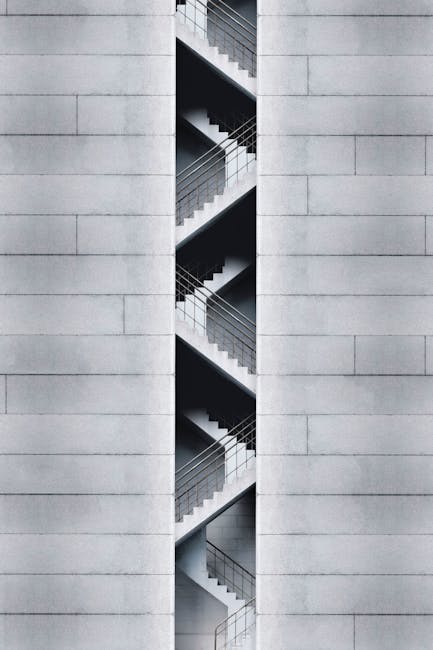 An artistic view of a modern staircase embedded in a concrete building facade in Taipei, Taiwan.